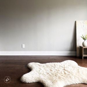 Minimalist brutalist interior design featuring raw concrete walls, exposed structural elements, and simple, functional furniture with clean lines, creating an industrial yet modern aesthetic.