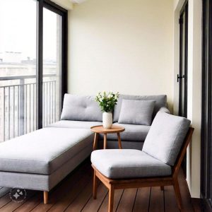 A modern home balcony design featuring a cozy seating area with cushioned chairs and a small coffee table, surrounded by lush green plants and soft ambient lighting, creating a relaxing outdoor retreat