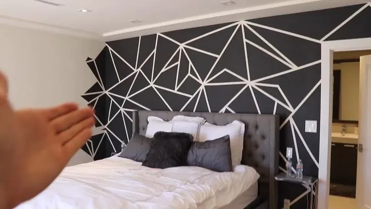 Bedroom wall color combination featuring a geometric black and white accent wall