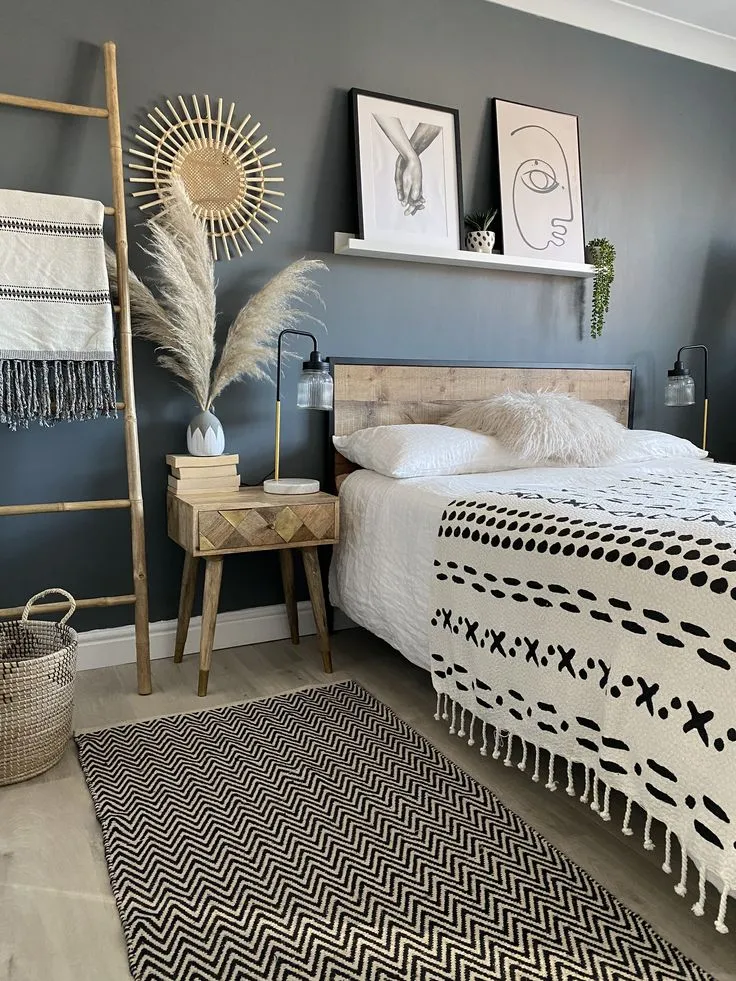 Boho bedroom with dark blue-gray walls, wood, and soft decor