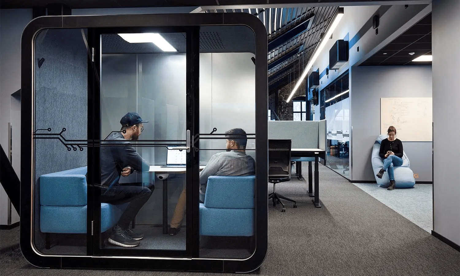 Indoor trees, crates, and city view in co-working office.