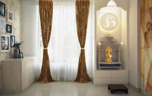 Modern white Mandir design for home with Om symbol.