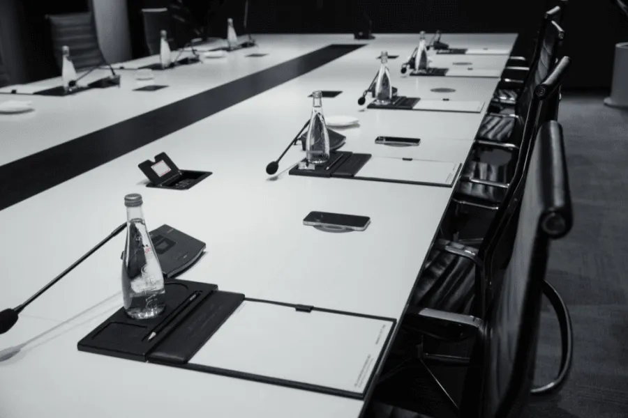 Meeting table with microphones and water bottles