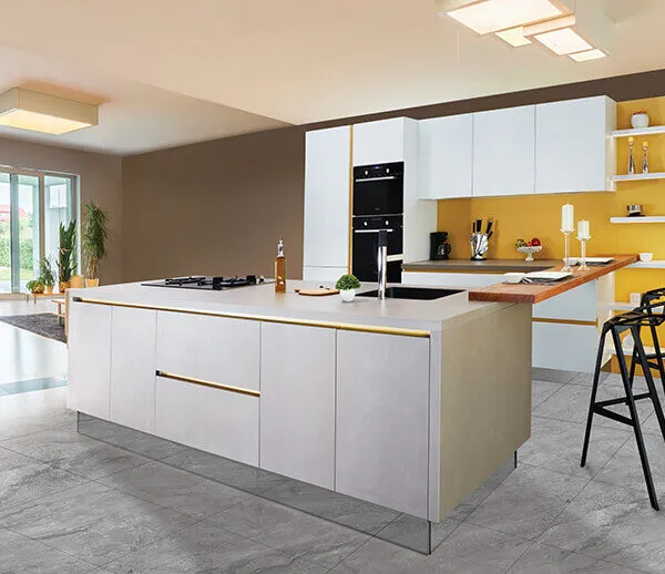 Modern island kitchen with sleek cabinetry and warm yellow accents.