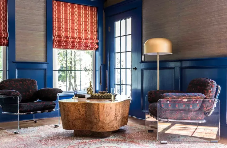 Eclectic room, blue walls, wood table, patterned chairs