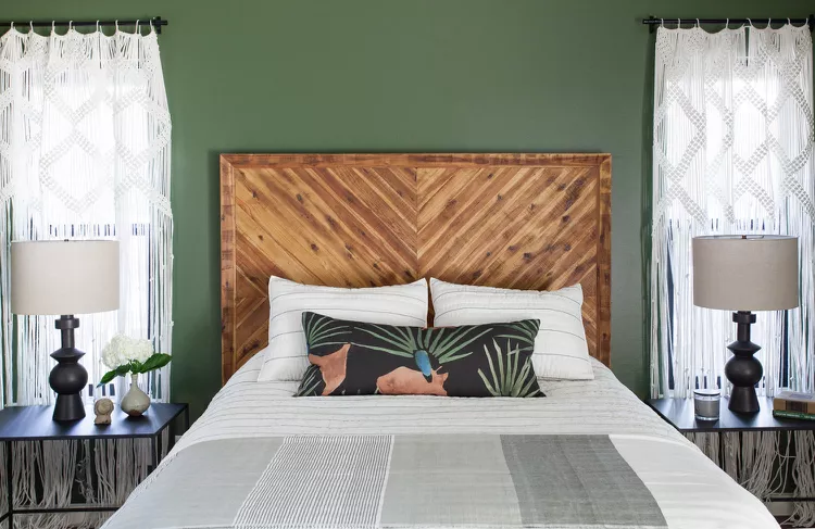 Cozy bedroom with a rustic wood headboard and green walls