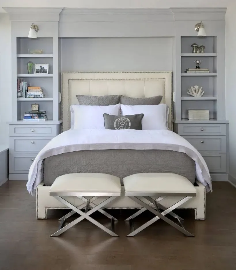 Elegant small master bedroom with built-in shelves and neutral tones.