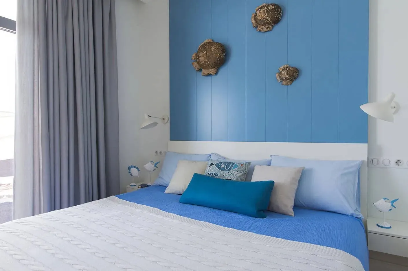 Coastal-themed bedroom with blue accents and marine decor.