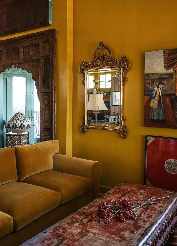 Vintage bohemian living room with warm mustard tones and decor