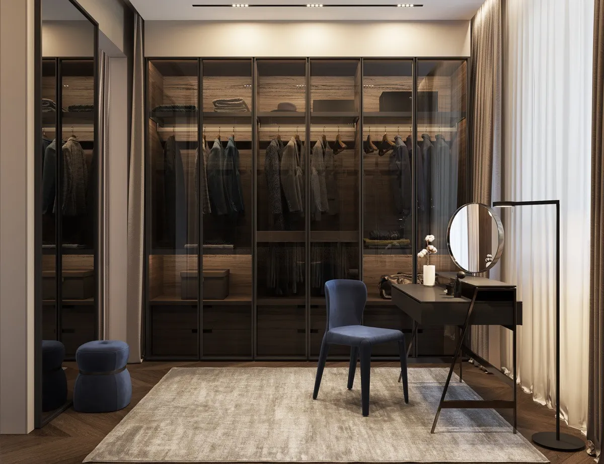 Modern walk-in wardrobe with glass cabinets, vanity, and neutral tones.