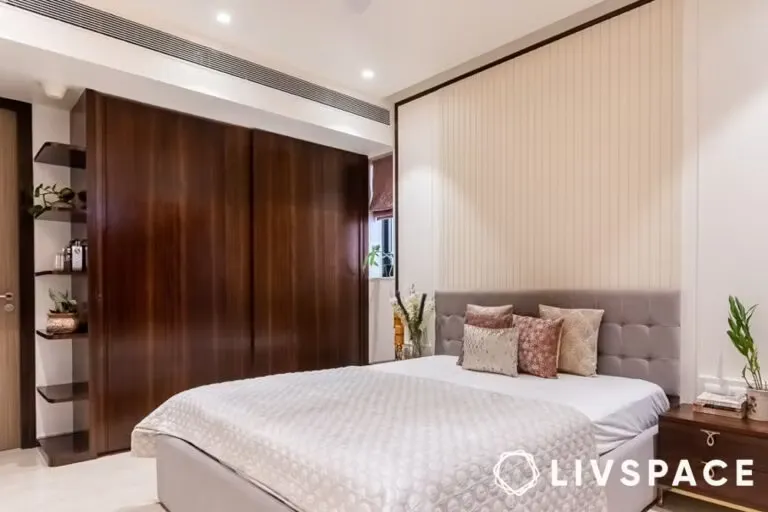 Contemporary bedroom with dark wood sliding wardrobe