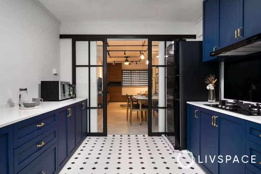 Blue kitchen, sliding doors, tile floor, Livspace interior guide.