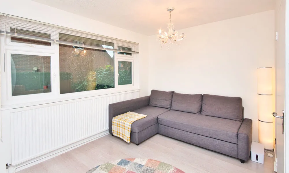 L-Shaped Sofa with gray sectional, colorful rug