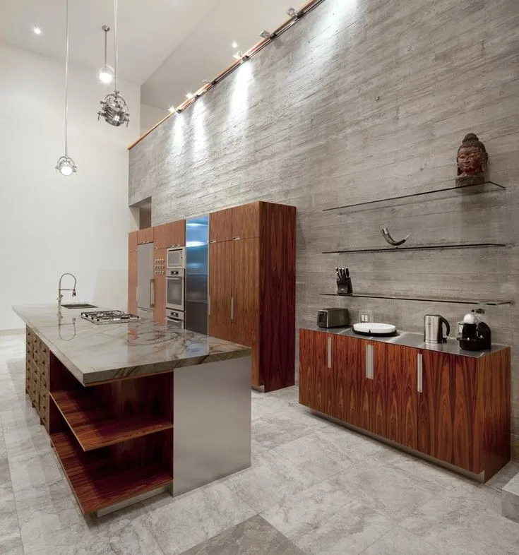 Modern kitchen interior, island, cabinets, lighting, concrete wall.