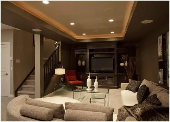 Warm basement with sofa and red chair BASEMENT PAINT COLOR