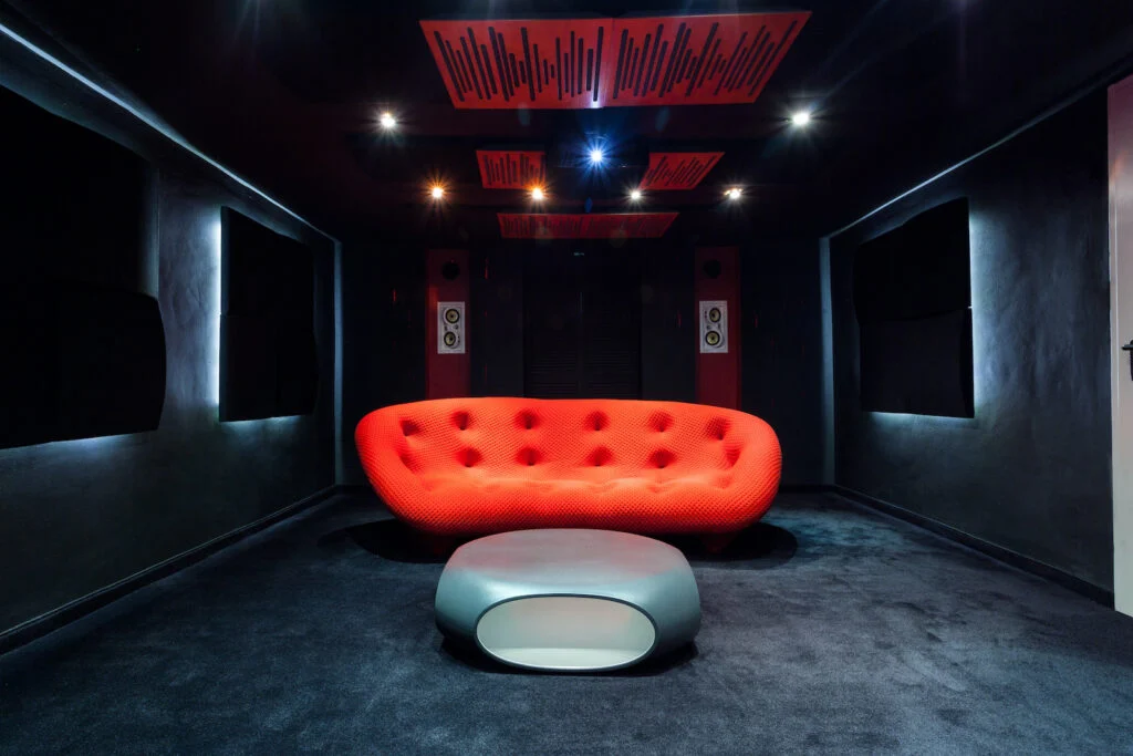 Dark media room with orange sofa BASEMENT PAINT COLOR