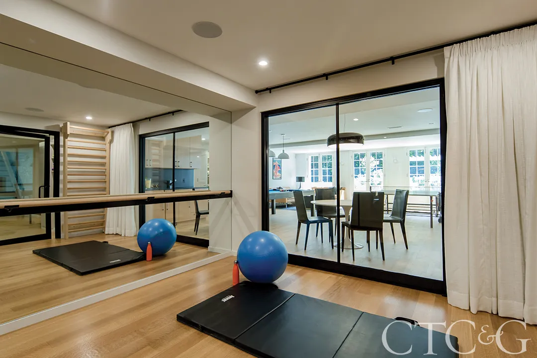 Modern gym with mirror and wood floor BASEMENT PAINT COLOR