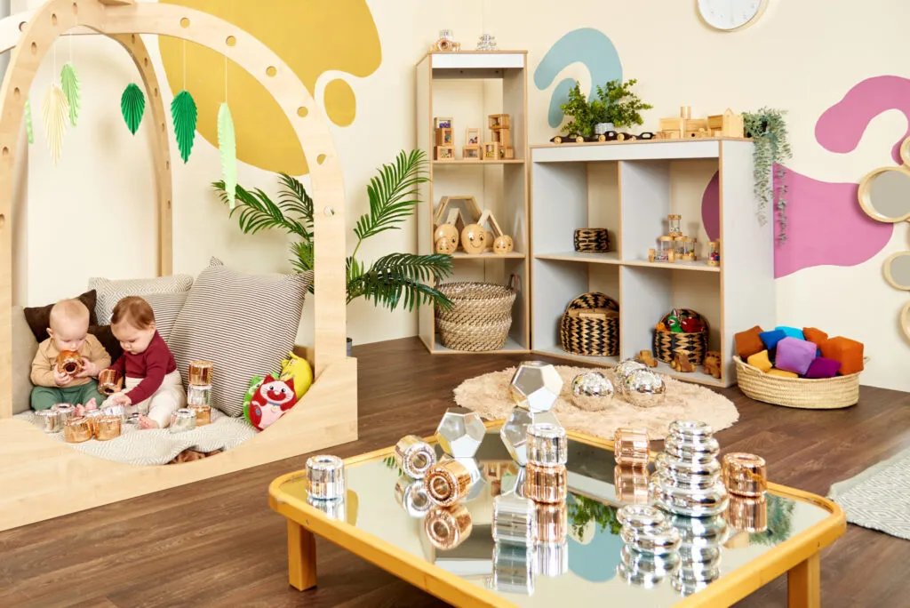 Modern nursery room with wooden play structures and sensory toys