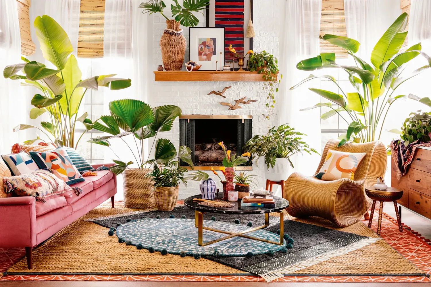 Small living room with pink sofa plants and patterns