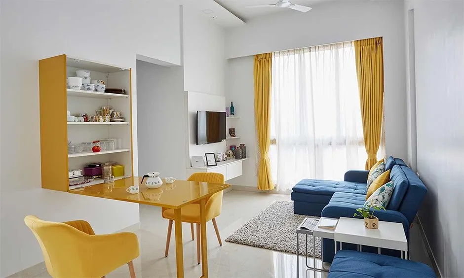 Small living room blue sofa yellow table white walls