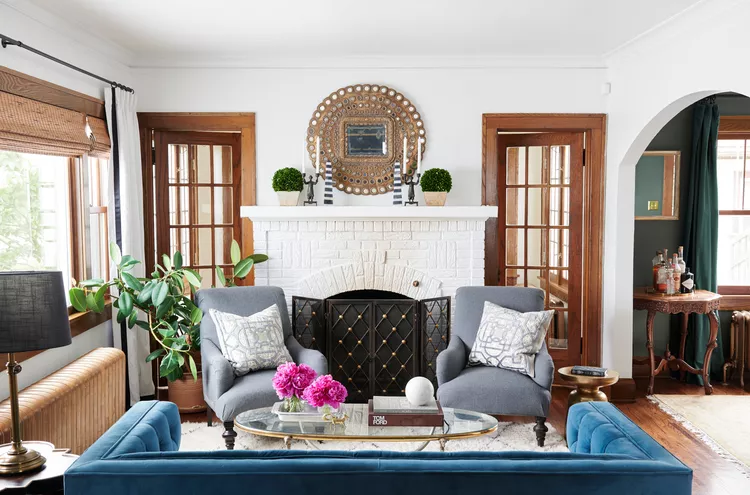 Small living room blue sofa gray chairs brick fireplace