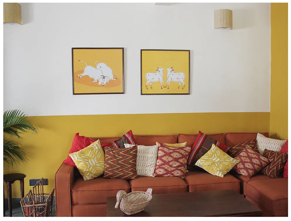 Small living room orange sofa art yellow wall pillows