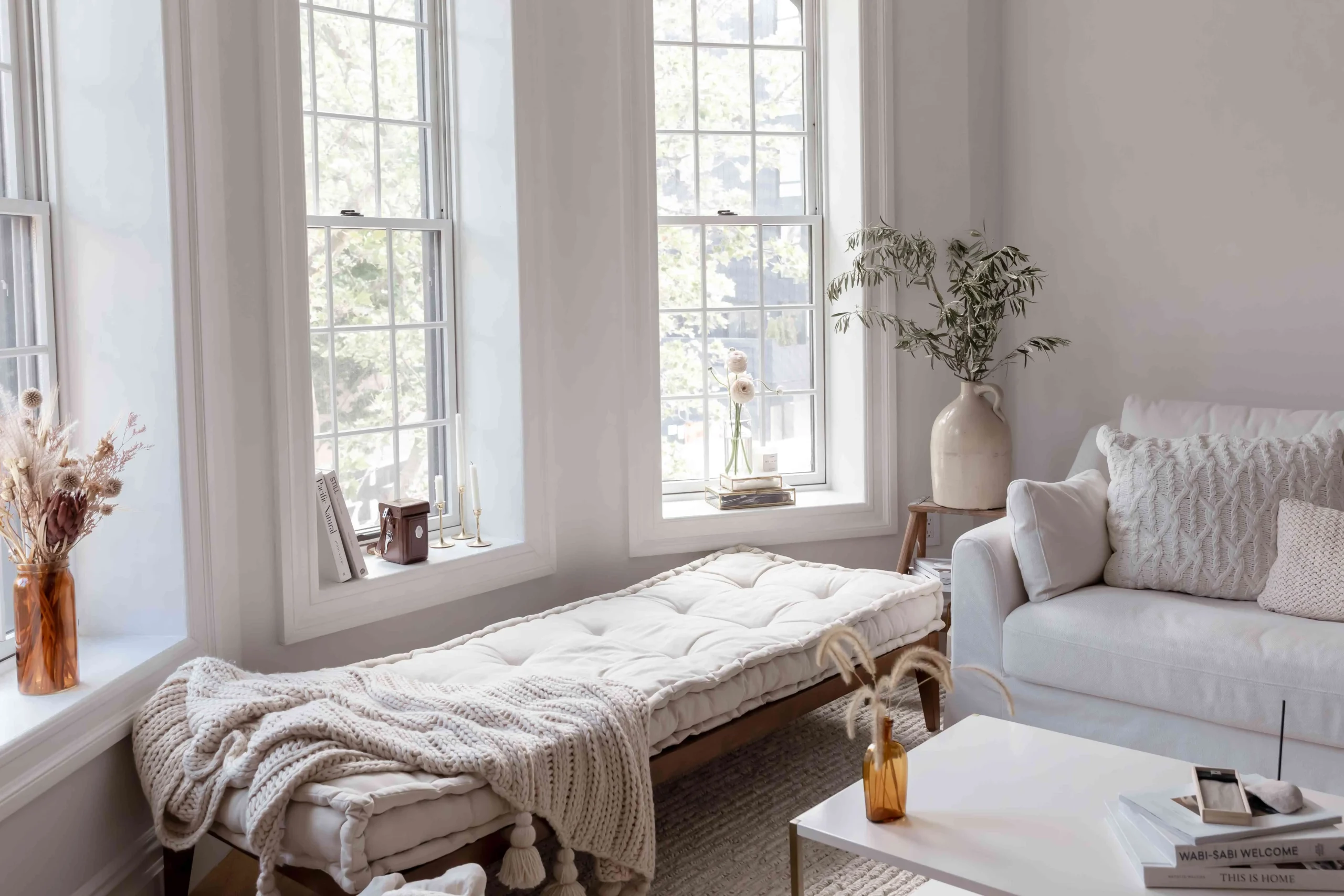 Small living room white sofa daybed wood floor plants