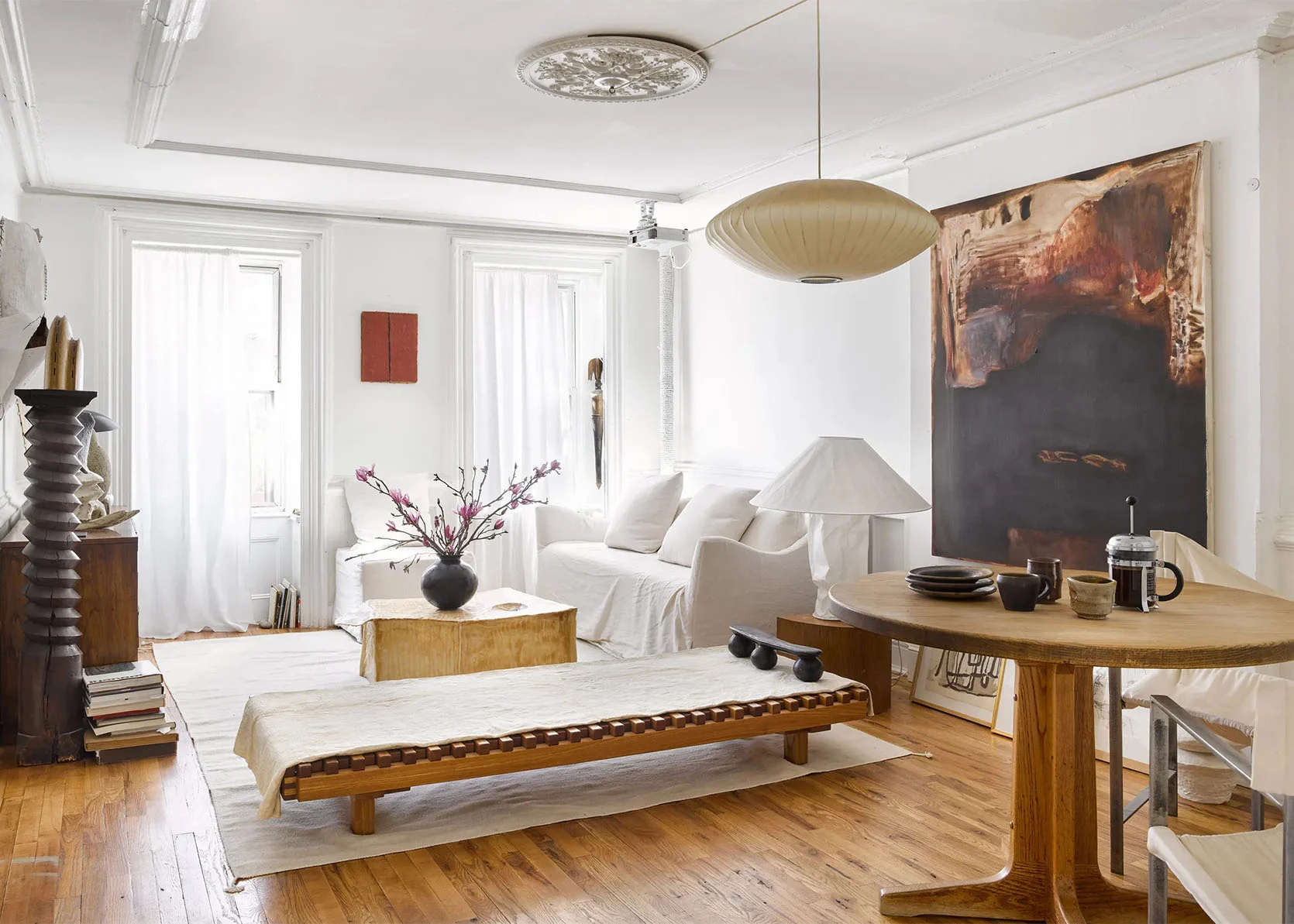 Small living room white sofa wood table art light floor.